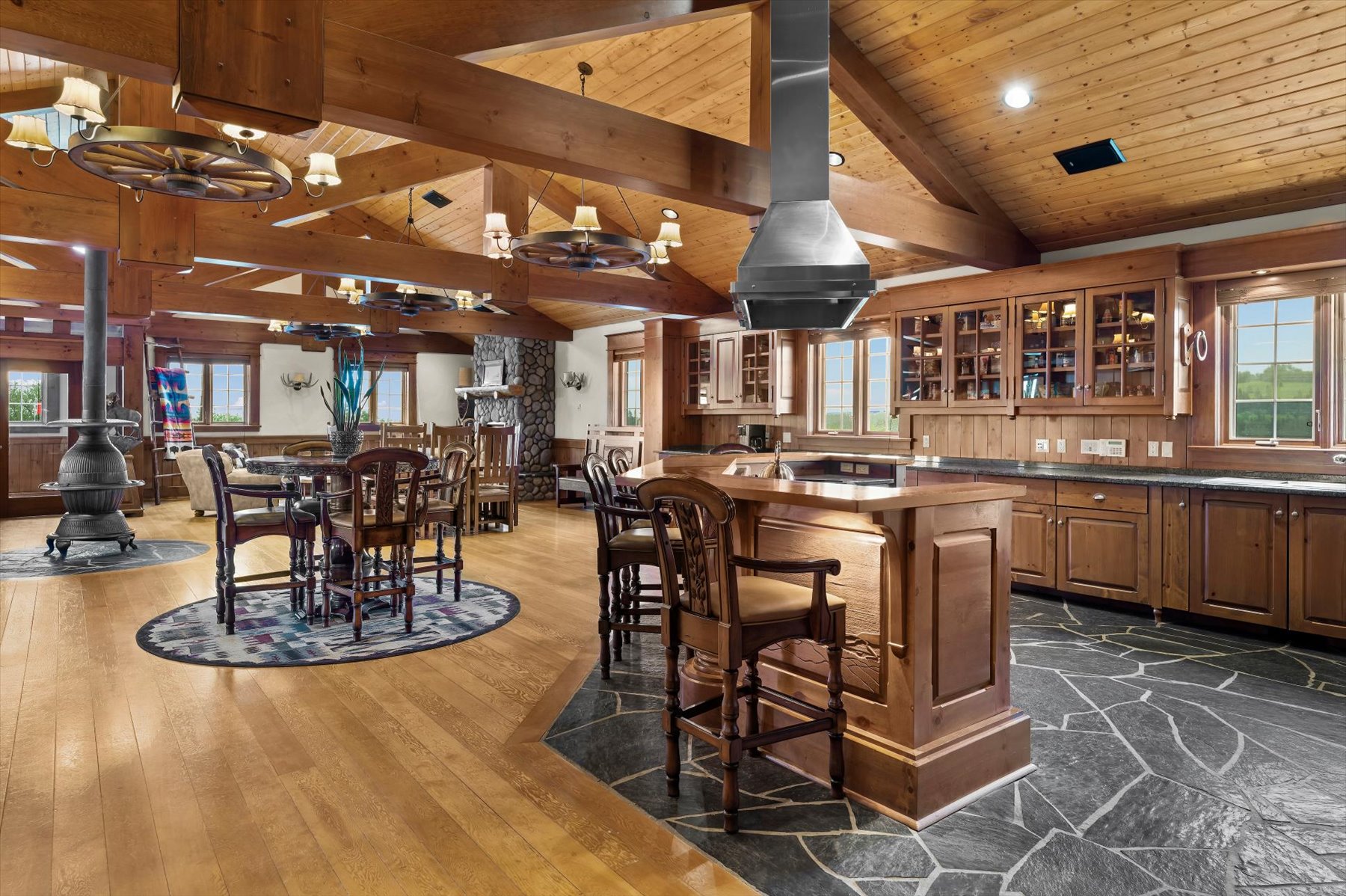 Chef's kitchen with copper-topped island, stainless hood and slate floor