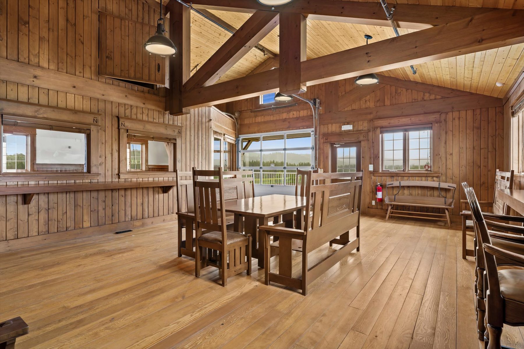 Timber-frame lounge above the barn with vaulted cedar ceiling and pasture views